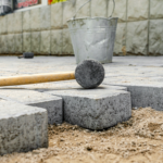rubber-hammer-gray-pavement-sand-laying-paving-stones-city